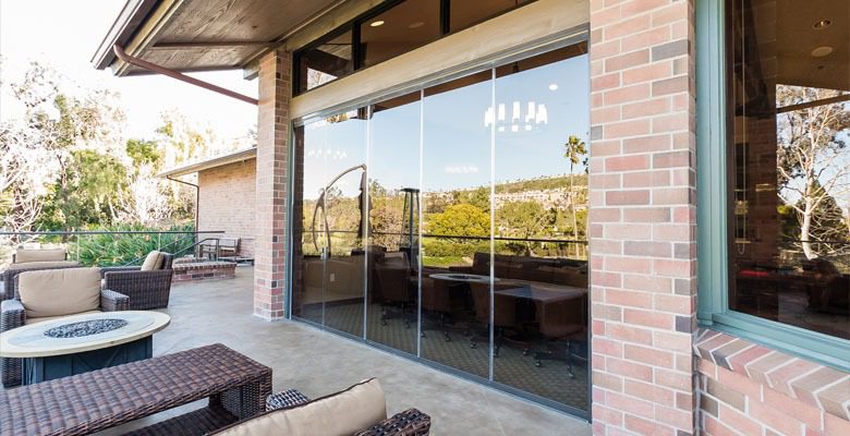 Outdoor resport patio with framless glass doors.