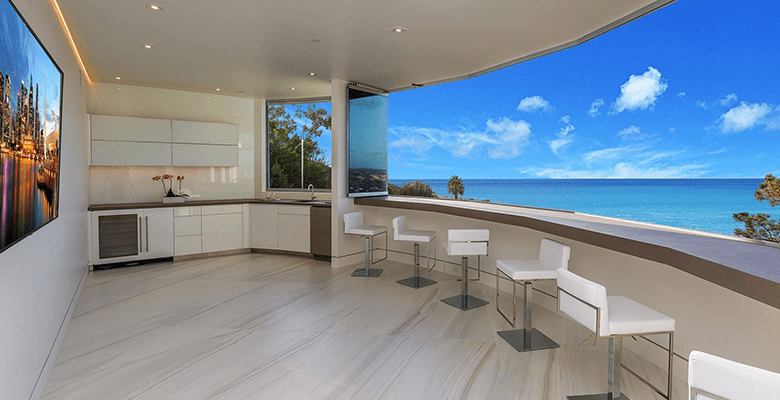 Curved glass walls overlooking the beach.