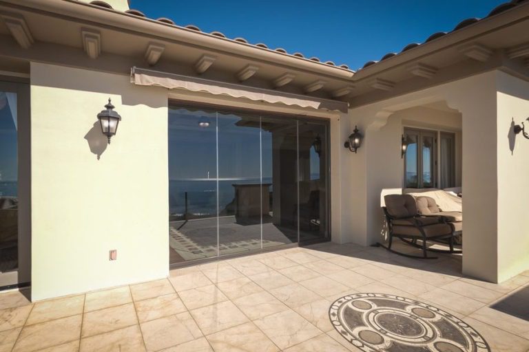 Patio with enclosed frameless sliding glass doors.