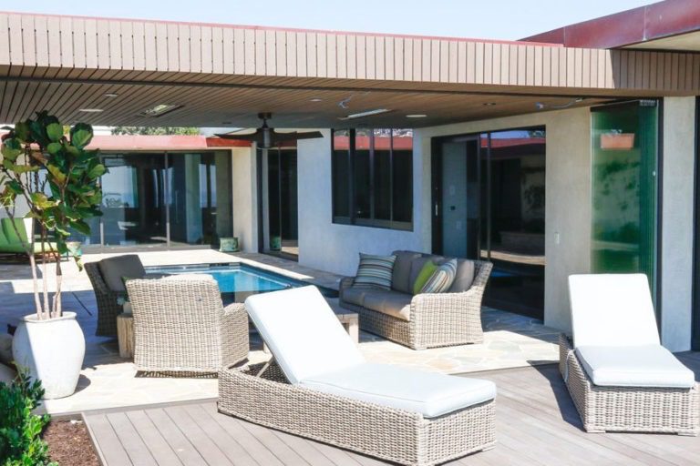 Stacked panels creating an open area between the yard and the indoor patio with swimming pool.