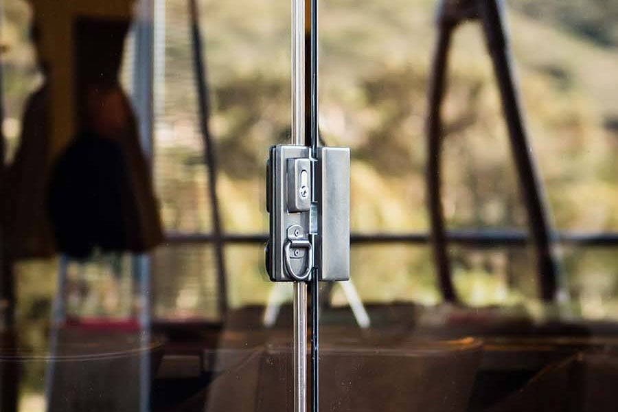 Zoomed in detail of a sliding glass panel's locking system.