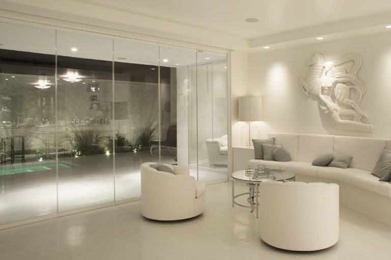 Intimate living room with enclosed frameless sliding glass doors.