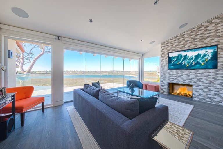 Living room with enclosed frameless sliding glass doors.