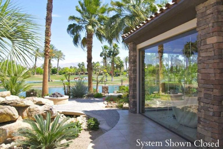 Overview of the country club residence featuring closed frameless sliding glass panels.