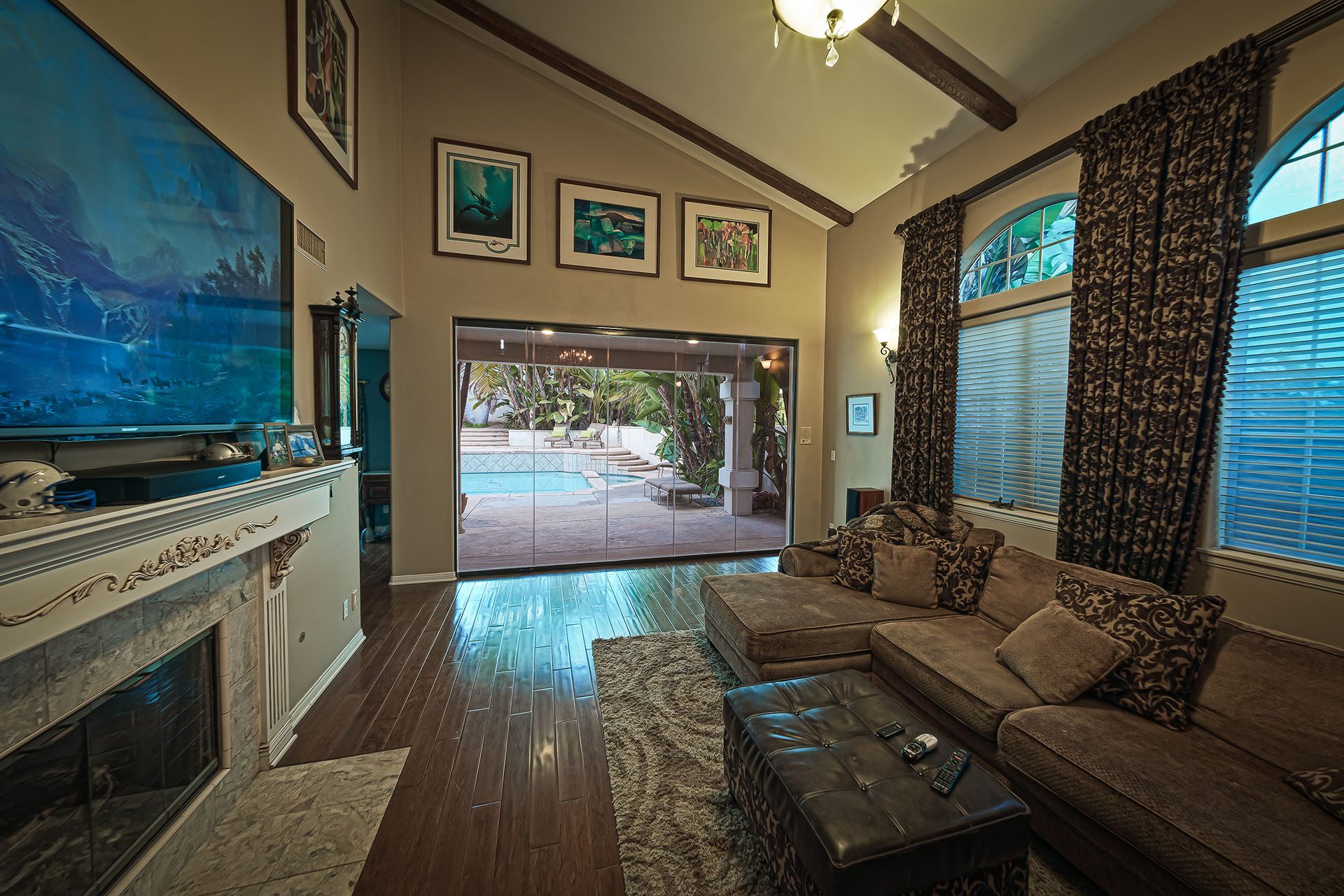 Frameless sliding glass doors enclosed in living room.