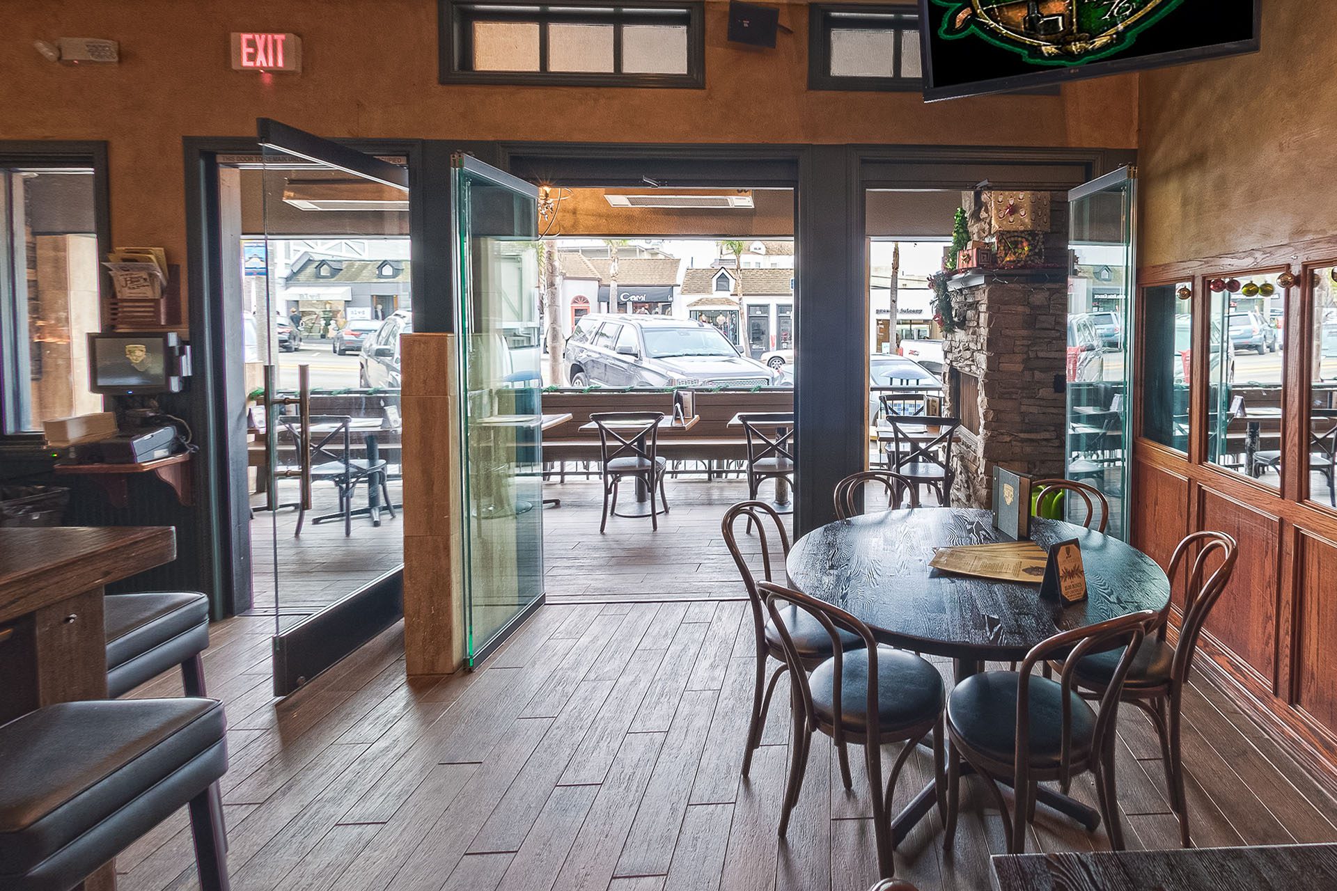 Opened frameless sliding glass doors with views of street.