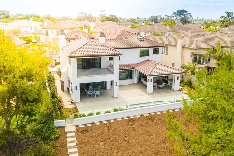 Property and front yard overview featuring frameless sliding glass doors.