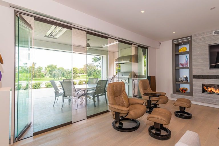 Partially open sliding glass doors connecting a living space with the outdoors.