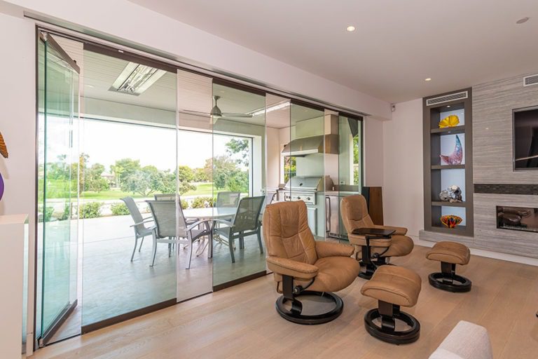 Partially open sliding glass panels connecting living space with the outdoors.