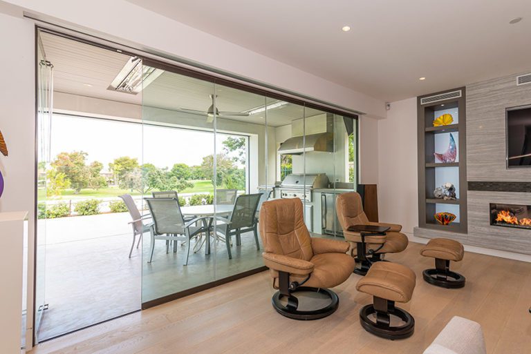 Sliding glass doors connecting a living space with the outdoors with first panel on the left open.