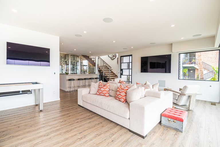 Beautifully designed interior of the open concept living room and bar with hints of orange red.