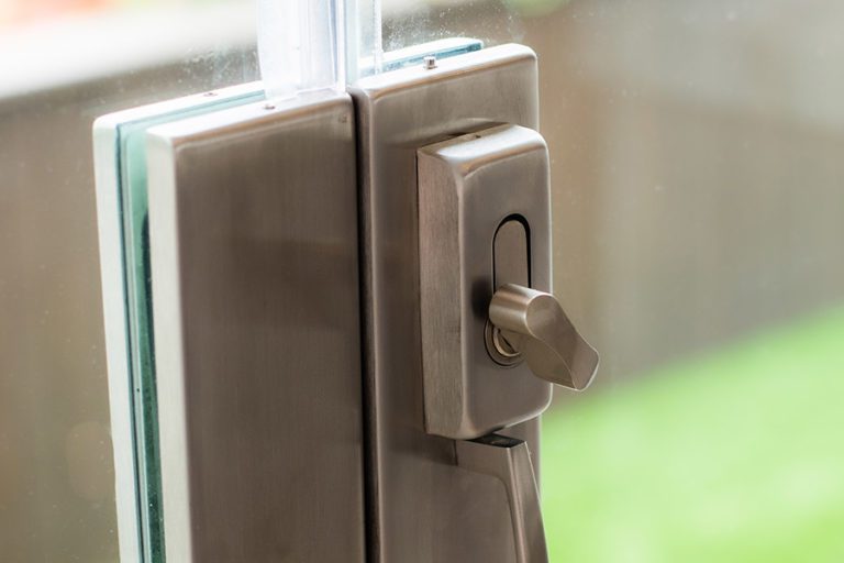 Lock handle to the frameless glass doors of the open concept living and kitchen room.