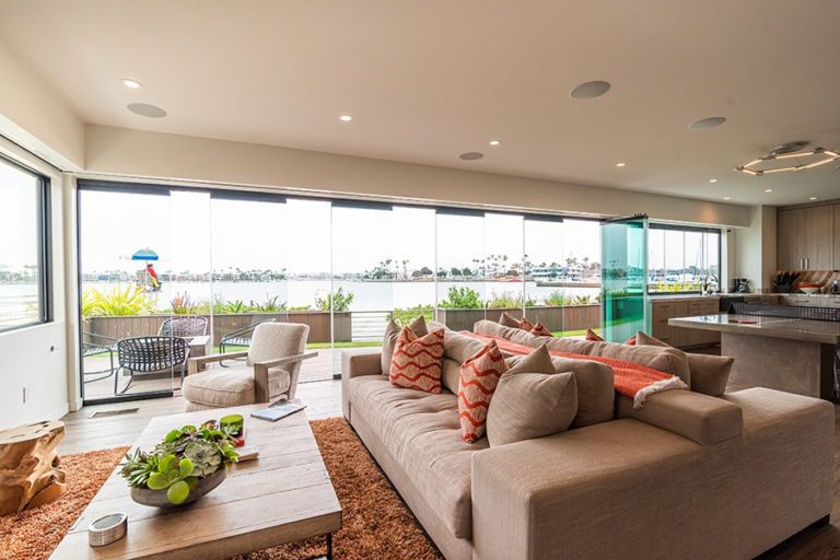 Unobstructed views of boat dock with spaced out frameless glass doors from open concept living room and kitchen.