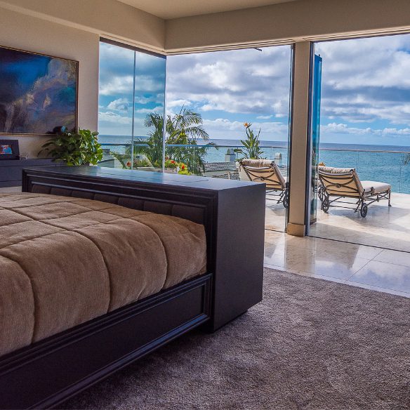 image of bedroom with frameless sliding glass doors