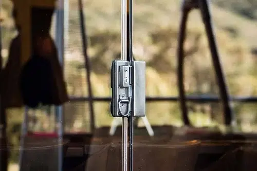 Zoomed in detail of a sliding glass panel's locking system.