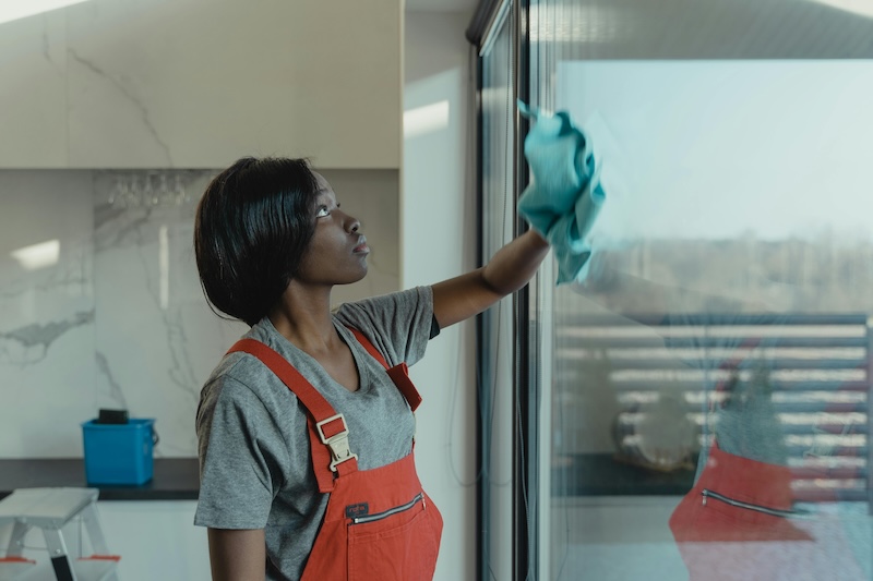 image of women cleaning sliding glass doors